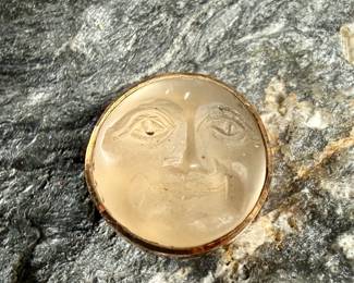 This lot features a carved "moon" moonstone set in 14k gold with a total approx. weight of 1.19 grams.

