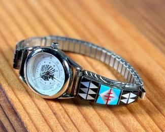 This lot features a beautiful artisan made Zuni watch band that appears to be signed by artist, "RB" as shown in photos.

