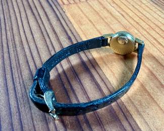 This lot features a vintage Omega ladies watch in a 18k gold case. Winds, but appears to need servicing to run properly. This is a small watch, measuring 24mm lug to lug.

