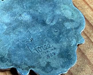 This lot features a sterling silver luggage tag by Foree that measures, 2.5” H x 1.75” W and has a total approx. weight of 30.52 grams.

