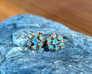 This lot features a pair of stunning 14k gold earrings, each containing seven (7) opals, circa 1940s. Total approx. weight of 2.58 grams.

