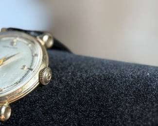 This lot features a vintage Hamilton "Fleetwood" manual-wind wristwatch in a 14k yellow gold case and black leather strap. Winds and runs. 36.5mm lug to lug.

