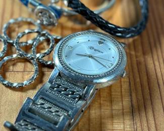 This lot features a collection of Brighton jewelry including scalloped stack rings, leather braided bracelets, and more. Founded in 1991 by Jerry and Terri Kohl, Brighton is a family-owned, Los Angeles-based design house specializing in high-quality, artisan-crafted, and often heart-themed accessories. Originating from a background in leather goods (starting in 1972), the brand blossomed into a premier jewelry maker known for its in-house design, intricate metalwork, and nickel-free materials.

