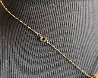 This lot features a Swarovski crystal pendant on a chain measuring, 18”.

