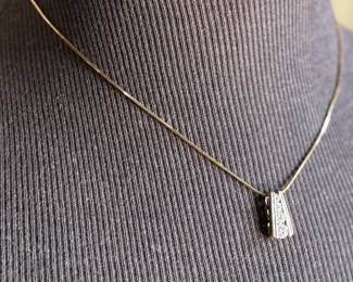 This lot features a beautiful sterling silver pendant with cz diamonds on a 925 chain measuring, 18”.

