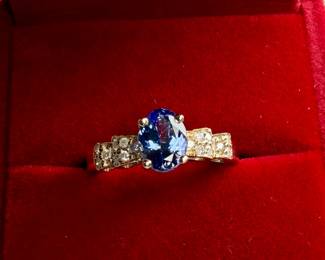 This lot features a 14k gold ring with genuine diamonds and tanzanite in a size 7 with a total approx. weight of 4.0 grams. Accompanied with an appraisal, this ring contains sixteen (16) round full cut diamonds and one (1) oval tanzanite.


