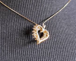 This lot features a stunning diamond heart pendant set in 14k gold on a 14k gold chain. The chain measures, 18” and this piece has a total approx. weight of 8.85 grams. The pendant contains genuine diamonds with a 1.50 carat weight.

