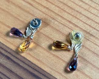 This lot features a pair of 14k gold earrings with what appears to be amethyst and citrine with a total approx. weight of 5.46 grams.

