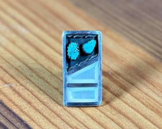 This lot features a beautiful Zuni ring, handcrafted by artist, Florentine Panteah. Signed by the artist and originally purchased in Jackson Hole, Wyoming. This ring comes in a size 5 and has a total approx. weight of 13.56 grams.

