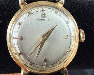 This lot features a vintage Hamilton "Fleetwood" manual-wind wristwatch in a 14k yellow gold case and black leather strap. Winds and runs. 36.5mm lug to lug.

