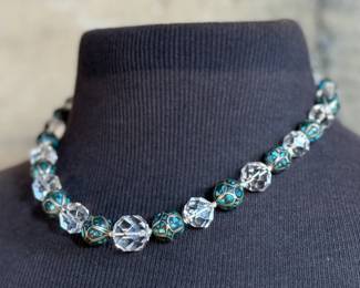 This lot features a beautiful necklace crafted from glass, turquoise, and sterling silver that measures, 18”.

