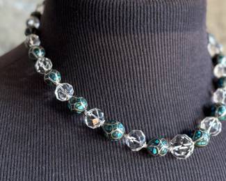 This lot features a beautiful necklace crafted from glass, turquoise, and sterling silver that measures, 18”.

