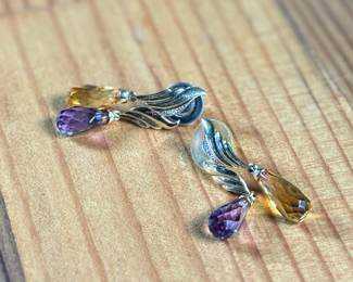 This lot features a pair of 14k gold earrings with what appears to be amethyst and citrine with a total approx. weight of 5.46 grams.

