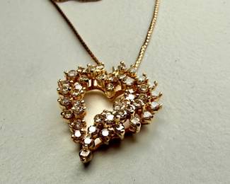 This lot features a stunning diamond heart pendant set in 14k gold on a 14k gold chain. The chain measures, 18” and this piece has a total approx. weight of 8.85 grams. The pendant contains genuine diamonds with a 1.50 carat weight.

