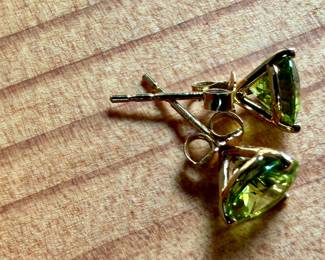 This lot features a pair of stunning 14k gold earrings with peridot and a total approx. weight of 1.23 grams.

