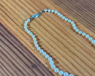 This lot features a graduated genuine pearl necklace with a 10k gold clasp measuring, 13”.

