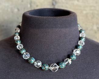This lot features a beautiful necklace crafted from glass, turquoise, and sterling silver that measures, 18”.

