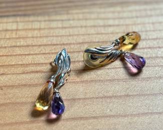 This lot features a pair of 14k gold earrings with what appears to be amethyst and citrine with a total approx. weight of 5.46 grams.

