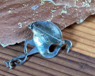 This lot features a hand made "flamingo" pin that measures 1.75” tall and crafted from sterling silver.

