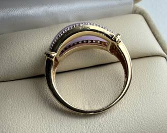 This lot features a 14k gold ring with lavender jadeite and genuine diamonds. The jadeite measures 17.7mm x 7.7mm and is set between two rows of single point diamonds. This ring comes in a size 7 with a total approx. weight of 4.42 grams.

