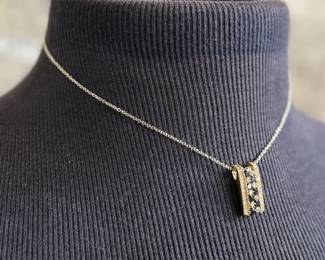 This lot features a stunning 14k yellow gold diamond & sapphire pendant on a gold-filled chain. The pendant comes with an appraisal (in the last photo). This pendant features thirty (30) round full cut diamonds measuring 1.5mm, seven (7) round full cut diamonds measuring 2.2mm, and seven (7) round faceted sapphires measuring 3.0mm. The pendant has a total approx. weight of 4.5 grams.

