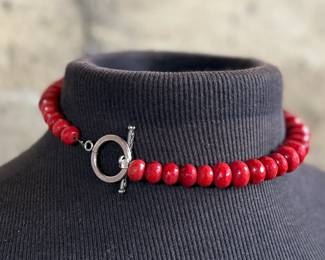 This lot features what is believed to be a graduated red coral necklace with a sterling silver clasp, measuring 17”.

