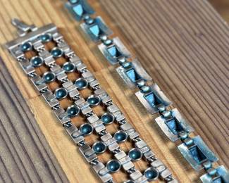 This lot features a necklace and bracelet by Renoir Copper. The necklace measures, 15” and the bracelet, 6.5”. Renoir copper jewelry is a highly collectible mid-century costume line produced by Jerry Fels in California from 1946 to 1964. Renowned for its abstract, modernist, and Arts & Crafts-inspired designs, the company specialized in solid, hand-hammered copper, frequently featuring bold, minimalist forms. 

