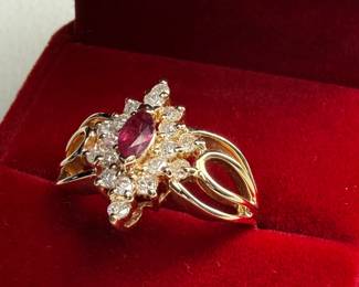 This lot features a 14k yellow gold ring with sixteen (16) round single cut genuine diamonds and one (1) marquise cut ruby. Accompanied with an appraisal, this ring comes in a size 7.75 with a total approx. weight of 4.6 grams.


