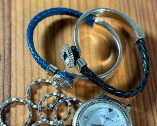 This lot features a collection of Brighton jewelry including scalloped stack rings, leather braided bracelets, and more. Founded in 1991 by Jerry and Terri Kohl, Brighton is a family-owned, Los Angeles-based design house specializing in high-quality, artisan-crafted, and often heart-themed accessories. Originating from a background in leather goods (starting in 1972), the brand blossomed into a premier jewelry maker known for its in-house design, intricate metalwork, and nickel-free materials.

