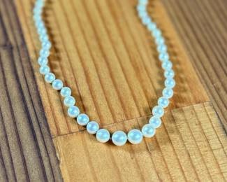 This lot features a graduated genuine pearl necklace with a 10k gold clasp measuring, 13”.

