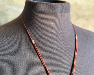 This lot features a Chinese necklace with red coral beads & coins. The necklace measures, 26”.

