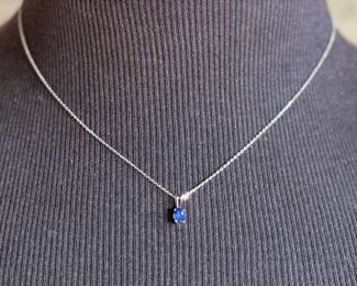 This lot features a sapphire pendant set in sterling silver on a 925 chain measuring, 17”.

