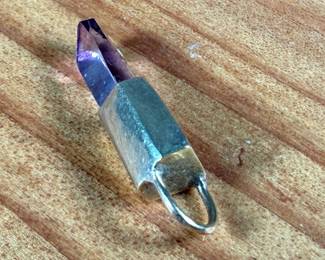 This lot features a 14k gold and amethyst pendant with a total approx. weight of 1.45 grams.

