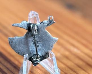 This lot features a vintage Taxco sterling silver “fish” pin.

