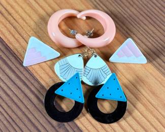 This lot features a curated collection of mid-century style earrings including a pair by Laurel Burch.

