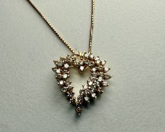This lot features a stunning diamond heart pendant set in 14k gold on a 14k gold chain. The chain measures, 18” and this piece has a total approx. weight of 8.85 grams. The pendant contains genuine diamonds with a 1.50 carat weight.

