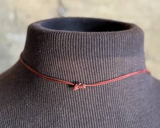 This lot features a Chinese necklace with red coral beads & coins. The necklace measures, 26”.

