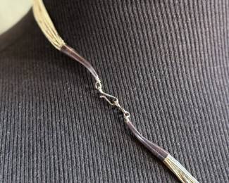 This lot features a stunning liquid silver and 14k gold necklace measuring, 23” with a total approx. weight of 27.57 grams.

