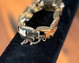 This lot features a 14k gold Leman watch with a total approx. weight of 28.5 grams. The watch is accompanied with an appraisal, is a manual wind with a 17-jewel Pathe Watch Co. movement, and runs/sets fine with safety clasp. The watch is 6.5” in length.

