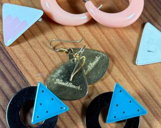 This lot features a curated collection of mid-century style earrings including a pair by Laurel Burch.

