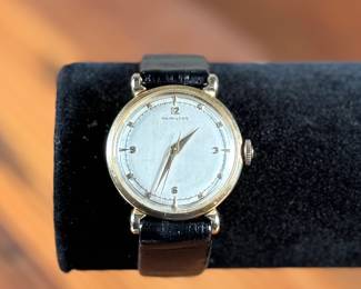 This lot features a vintage Hamilton "Fleetwood" manual-wind wristwatch in a 14k yellow gold case and black leather strap. Winds and runs. 36.5mm lug to lug.

