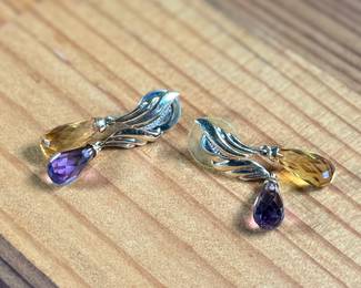 This lot features a pair of 14k gold earrings with what appears to be amethyst and citrine with a total approx. weight of 5.46 grams.

