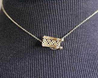 This lot features a stunning 14k yellow gold diamond & sapphire pendant on a gold-filled chain. The pendant comes with an appraisal (in the last photo). This pendant features thirty (30) round full cut diamonds measuring 1.5mm, seven (7) round full cut diamonds measuring 2.2mm, and seven (7) round faceted sapphires measuring 3.0mm. The pendant has a total approx. weight of 4.5 grams.

