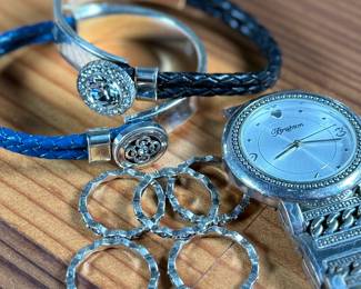 This lot features a collection of Brighton jewelry including scalloped stack rings, leather braided bracelets, and more. Founded in 1991 by Jerry and Terri Kohl, Brighton is a family-owned, Los Angeles-based design house specializing in high-quality, artisan-crafted, and often heart-themed accessories. Originating from a background in leather goods (starting in 1972), the brand blossomed into a premier jewelry maker known for its in-house design, intricate metalwork, and nickel-free materials.

