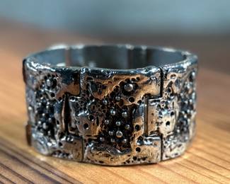 This lot features a brutalist style bracelet by designer Robert Larin, circa 1970s. This piece measures, 7” and is signed as shown in photos.

