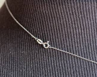 This lot features a sapphire pendant set in sterling silver on a 925 chain measuring, 17”.

