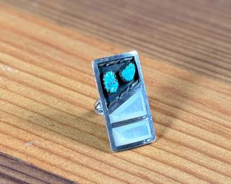 This lot features a beautiful Zuni ring, handcrafted by artist, Florentine Panteah. Signed by the artist and originally purchased in Jackson Hole, Wyoming. This ring comes in a size 5 and has a total approx. weight of 13.56 grams.

