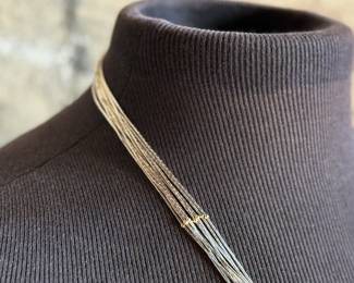 This lot features a stunning liquid silver and 14k gold necklace measuring, 23” with a total approx. weight of 27.57 grams.

