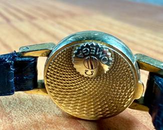 This lot features a vintage Omega ladies watch in a 18k gold case. Winds, but appears to need servicing to run properly. This is a small watch, measuring 24mm lug to lug.

