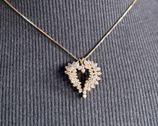 This lot features a stunning diamond heart pendant set in 14k gold on a 14k gold chain. The chain measures, 18” and this piece has a total approx. weight of 8.85 grams. The pendant contains genuine diamonds with a 1.50 carat weight.

